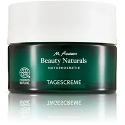 Grünes Glasgefäß mit weißem Deckel für Naturkosmetik-Tagescreme.